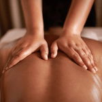 hands performing massage on a back