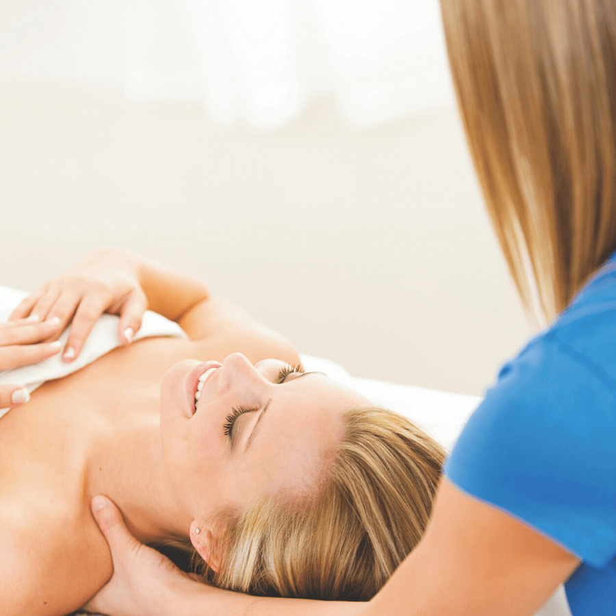 massage therapist massaging client's shoulders