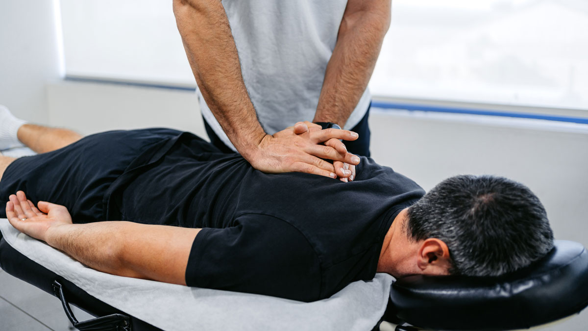 man lying down on massage table receiving massage