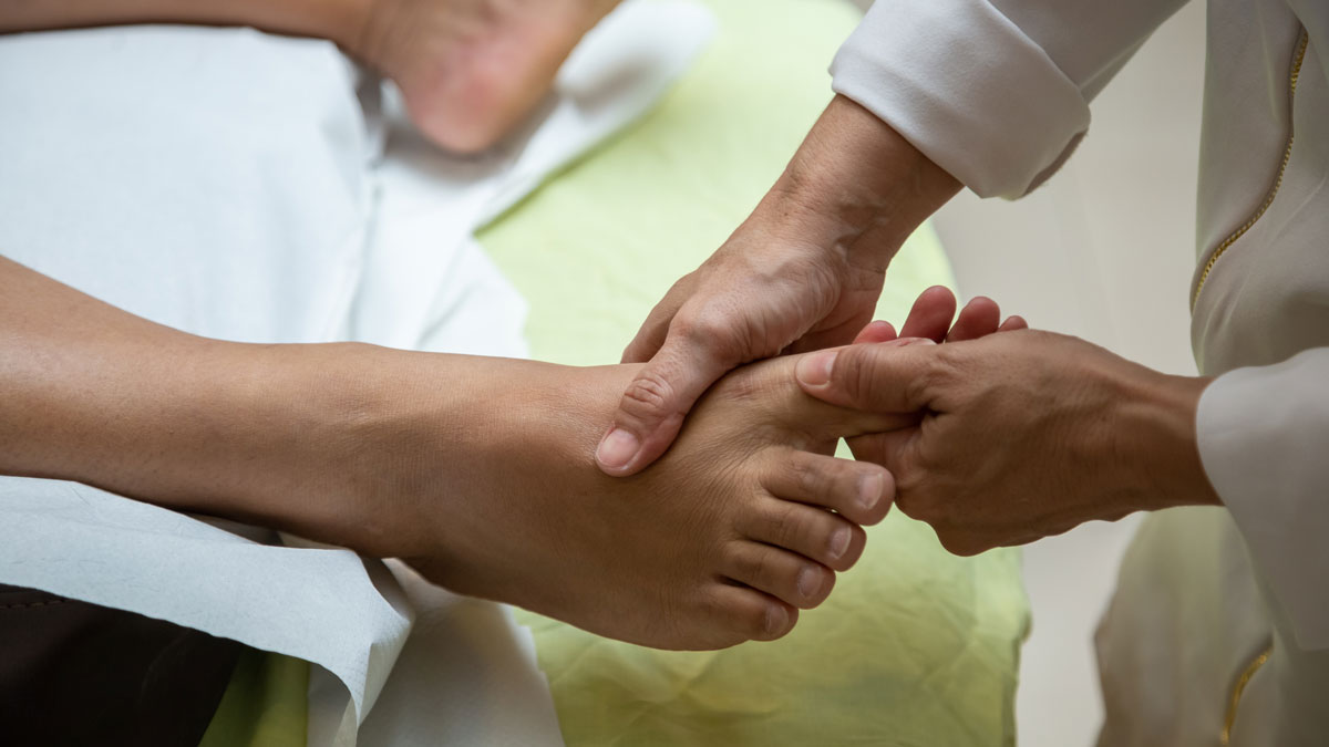 person with neuropathy receiving foot massage