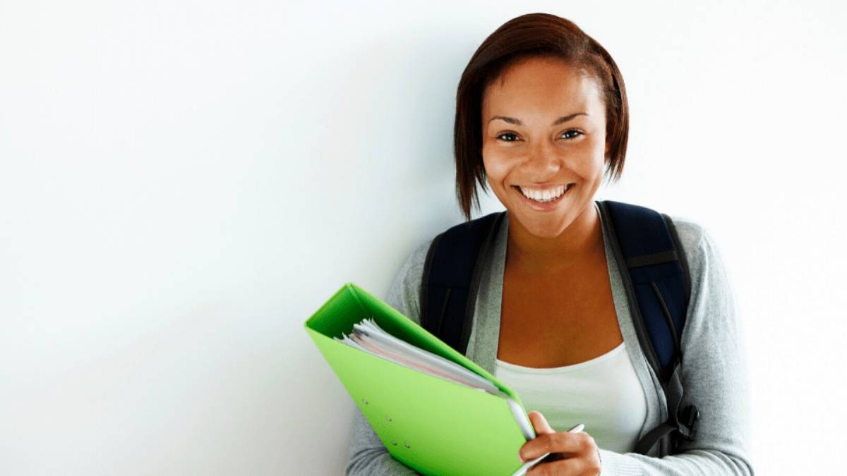 smiling female student holding notebook
